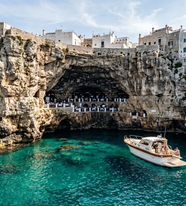Luxury boat anchored near Grotta Palazzese sea cave in Polignano a Mare with turquoise water