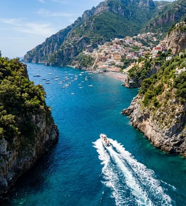 Aerial view of a private speedboat cruising between green cliffs toward Positano village