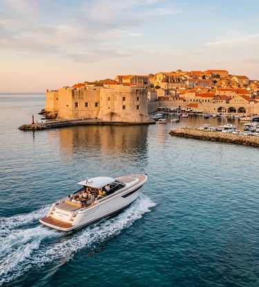 Private speedboat cruising past Dubrovnik old town walls at golden hour