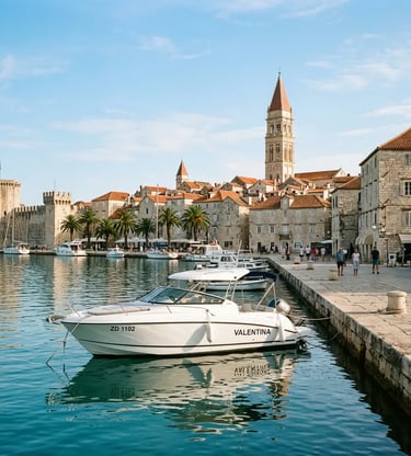 Luxury speedboat moored at Trogir stone promenade with cathedral bell tower in background
