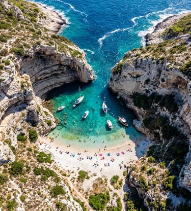 Aerial view of Stiniva Cove on Vis Island with turquoise water and boats anchored near beach