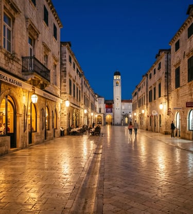Empty Stradun marble boulevard in Dubrovnik lit by warm street lamps at dusk