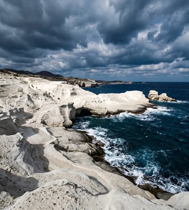 White volcanic rock formations of Sarakiniko beach in Milos with dramatic clouds and deep blue sea