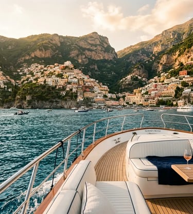 Luxury yacht deck with white cushions approaching Positano village on the Amalfi Coast