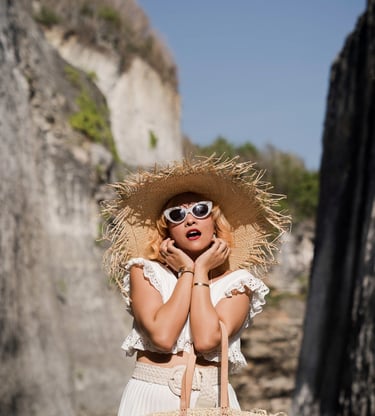 Portrait of woman wearing sun hat during beach photoshoot at Melasti Beach Bali