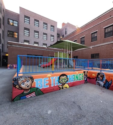 An exterior wall of a school play area after adding images of children and painting the rails.