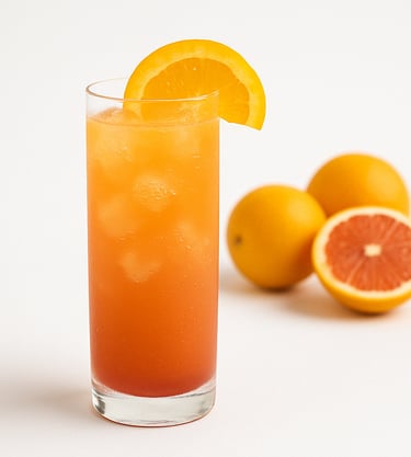 Orange drink with ice cubes and oranges in the background