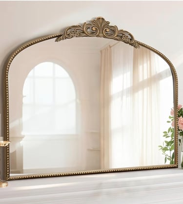 Large arched gold vanity mirror with an ornate vintage frame detail at the top.