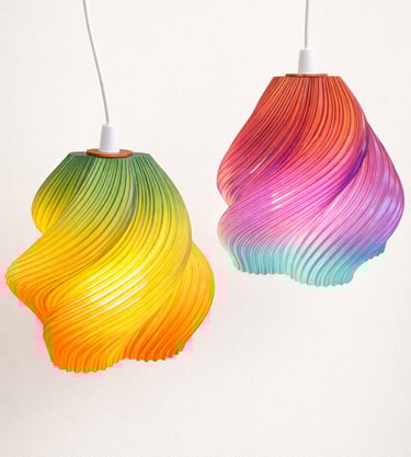 Set of custom 3D printed spiral lamps in multiple colors on neutral background