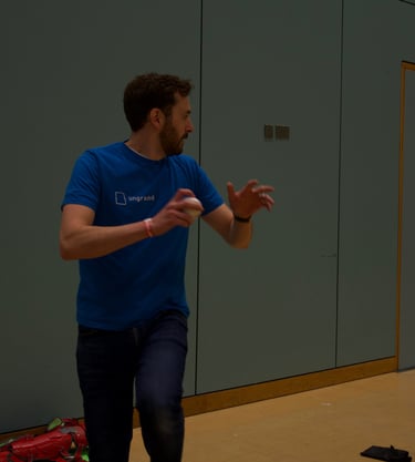 a man in a blue shirt is playing with a baseball bat