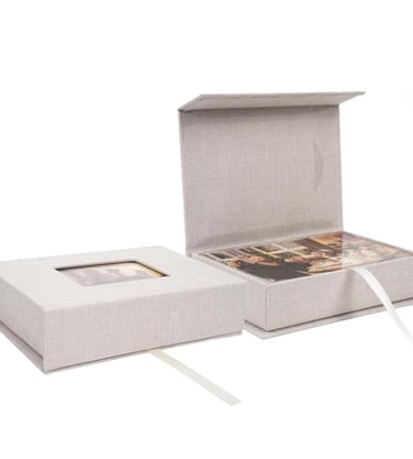 Handmade linen photo storage boxes with magnetic lids and ribbon pull for organizing family memories.