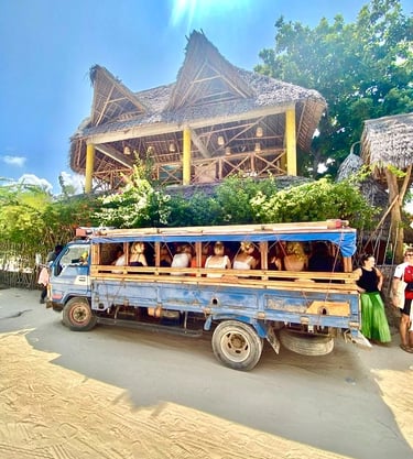 Tourists riding a traditional Zanzibar Daladala, the local bus used to travel to shamba, experiencing authentic village life
