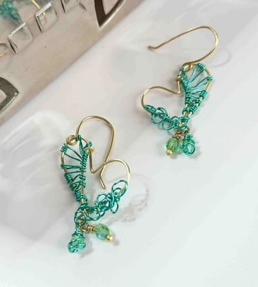 Quirky skew heart brass earrings, weaved witj green amd curls details 