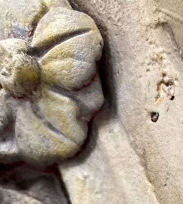 Extreme detail shot of a Victorian flower ornament painted to look like sandstone.