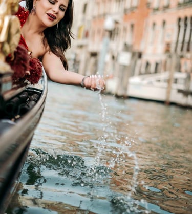 Woman in red dress on gondola in Venice