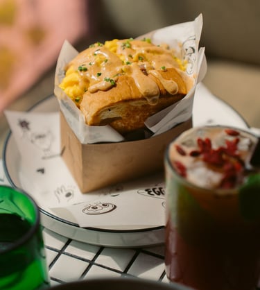 a table with a bowl of soup and a sandwich