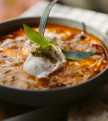 a bowl of soup with a fork and a fork