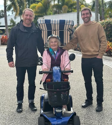 the owners of sunshine coast mobility posing with a happy customer on her rented mobility scooter