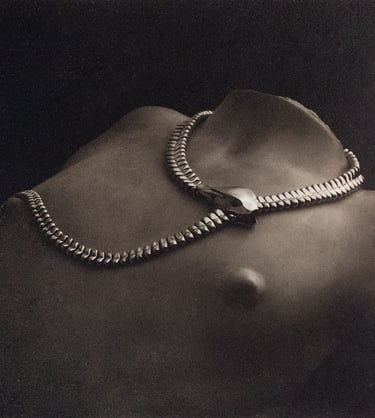 Platinum and silver art photo of a a snake necklace by Tiffany & Co on a woman's torso in marble
