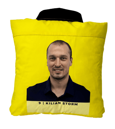 a yellow shirted pillow with a printed portrait on the back