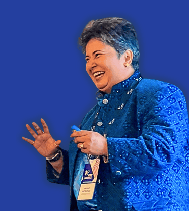 a woman in a blue jacket sharing a joke with audience during keynote