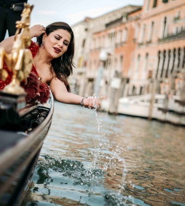 Woman in red dress on gondola in Venice