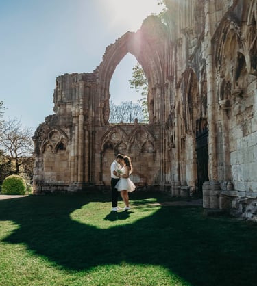 Bride standing near historic stone ruins in York, photographed by Fred Art Studio.