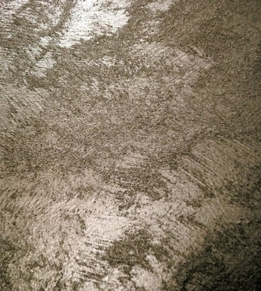 A warm silver paint sample showing its lustre and beautiful grainy texture.