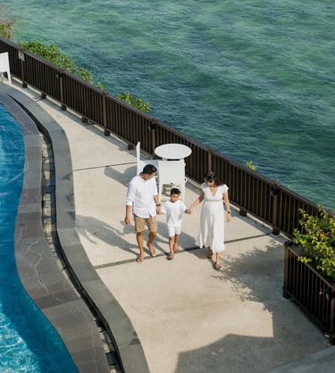 Family walking by the ocean during a relaxed family session at Anantara Uluwatu.
