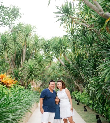 Family portrait surrounded by tropical garden at The Mulia Nusa Dua Bali