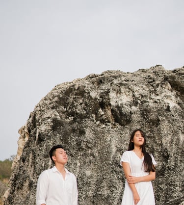 Couple portrait on a rocky cliff during proposal photoshoot at Melasti Beach Bali