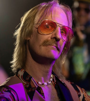 Portrait of a man with a mustache and sunglasses on a stage