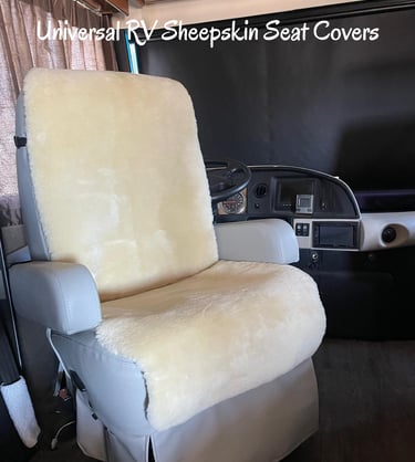 Cream universal sheepskin seat covers installed on a motorhome driver seat for RV comfort.