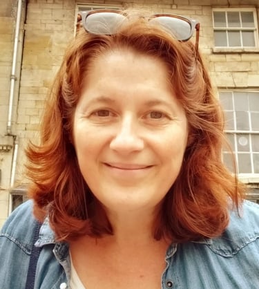 a head shot of the owner of Kemend wearing sunglasses on the top of her head