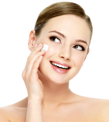 Smiling woman applying facial cream for radiant skin, promoting beauty and skincare routines.