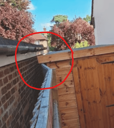 www.truthincontext.co.uk Displaced fence panels. posts and rainwater drains off from sloped roof