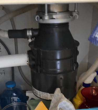a garbage disposal under a sink in a kitchen