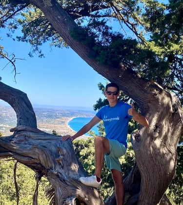 a man standing on a tree branch in a tree