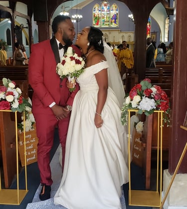 a bride and groom standing in front of a church