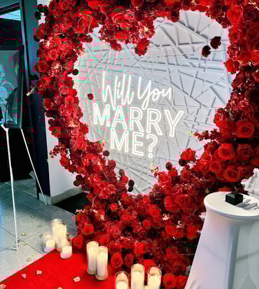 A heart-shaped arrangement of silk roses in shades of red,
