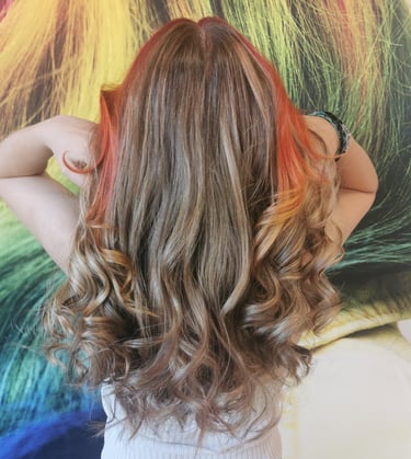 a woman with long hair and a rainbow colored hair
