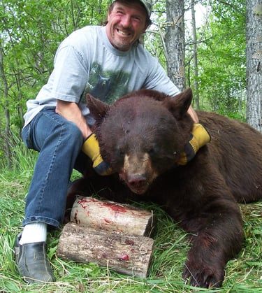 Saskatchewan outfitter Kim Tiringer with giant colored black bear
