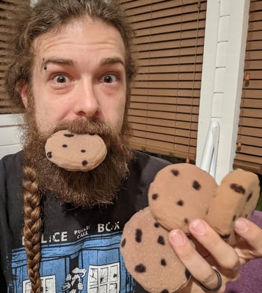 man holding plush cookies