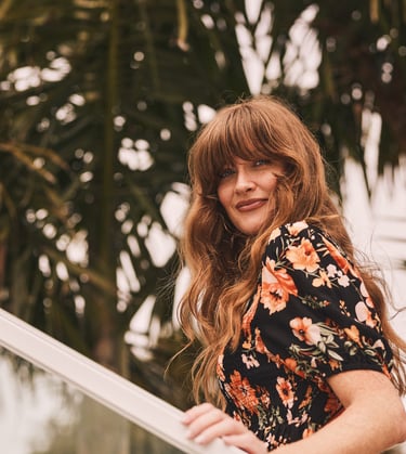 Fashion photography - a woman in a floral dress standing on a staircase