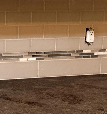 a kitchen counter top with a clock on the counter