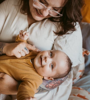 a woman holding a baby in her arms