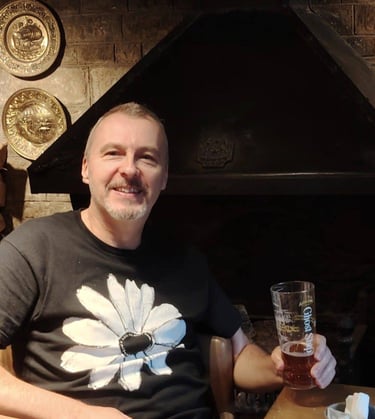 Author Jon Clynch by a cosy open fireplace in an ancient English public house.