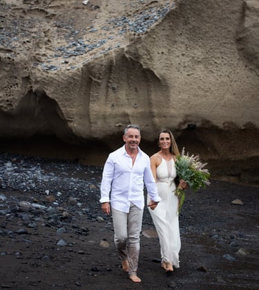 Couple walking on the beach during their wedding photoshoot.