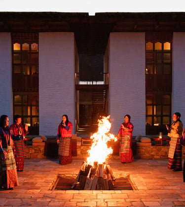 Bhutanese-women-performing-folk-songs-and-dances-during-cultural-show-over-firepit-at-amankora-Lodge
