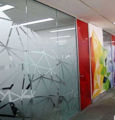 a wall of glass with a colorful wallpaper